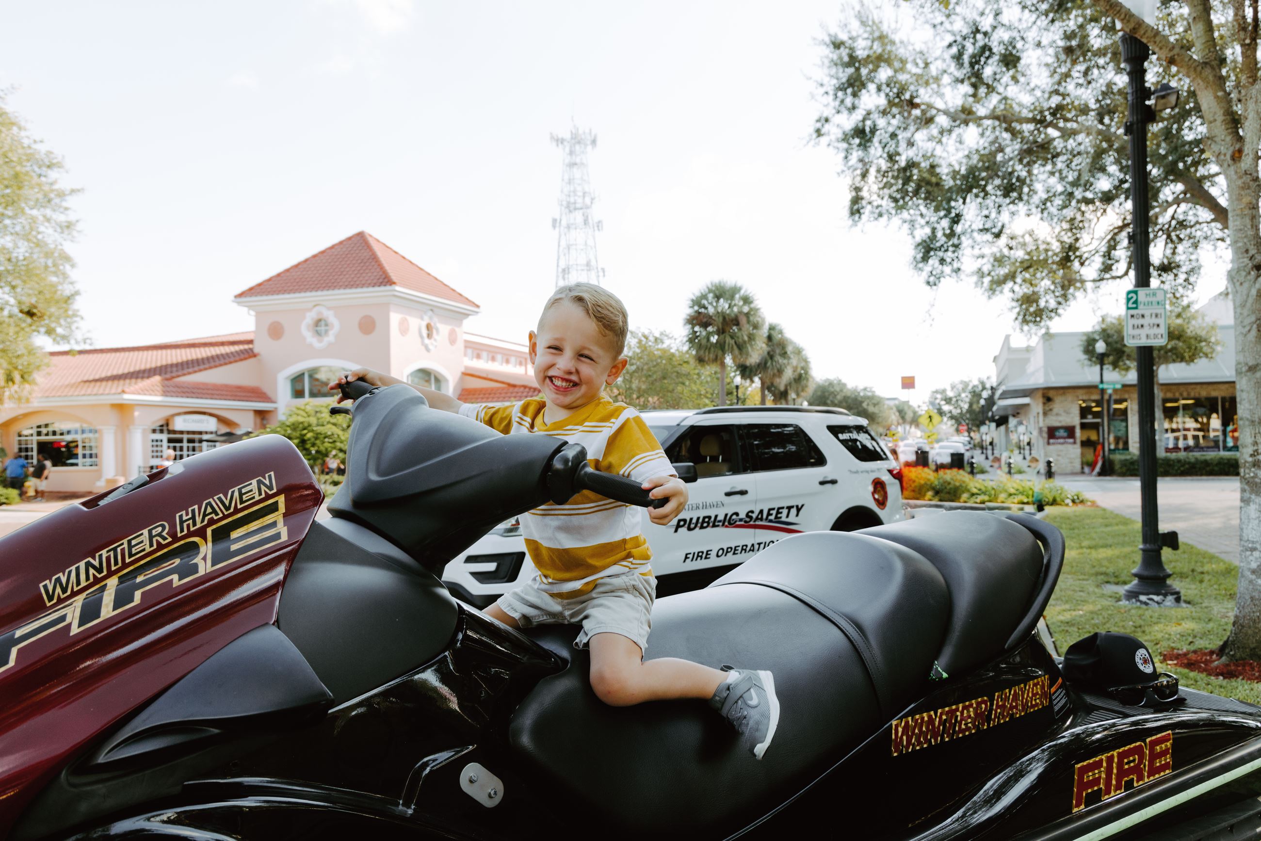 Young boy sitting on the Winter Haven Fire Department jet ski with a big smile on his face. 